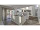 Open floor plan with a sliding glass door that leads to an outdoor patio and an adjacent kitchen at 43324 W Desert Fairways Dr, Maricopa, AZ 85138