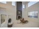 Bright living room with fireplace, high ceilings, and neutral decor at 43324 W Desert Fairways Dr, Maricopa, AZ 85138