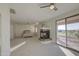 Large main bedroom featuring a fireplace, ceiling fan and outdoor access to a patio at 43324 W Desert Fairways Dr, Maricopa, AZ 85138