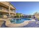 Stunning backyard pool and pebble tec deck with desert landscaping, perfect for entertaining and relaxation at 43324 W Desert Fairways Dr, Maricopa, AZ 85138
