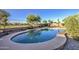 Serene backyard pool surrounded by desert landscaping and wrought iron fencing, offering a private outdoor oasis at 43324 W Desert Fairways Dr, Maricopa, AZ 85138