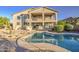 Gorgeous private pool with a Baja shelf, surrounded by desert landscaping in a luxurious backyard setting at 43324 W Desert Fairways Dr, Maricopa, AZ 85138
