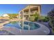 Inviting backyard pool with a pebble tec finish surrounded by desert landscaping, perfect for relaxation and entertaining at 43324 W Desert Fairways Dr, Maricopa, AZ 85138
