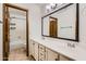 Bathroom features double sinks with a large mirror, white cabinets, and a shower with a tub at 514 E Vaughn Ave, Gilbert, AZ 85234