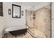 Updated bathroom featuring a soaking tub and separate tile shower with glass doors at 514 E Vaughn Ave, Gilbert, AZ 85234