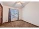 Bedroom showcases neutral walls, carpet, a modern ceiling fan and natural light from the window at 514 E Vaughn Ave, Gilbert, AZ 85234
