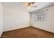 This bedroom has neutral walls, carpet, a modern ceiling fan and natural light from the window at 514 E Vaughn Ave, Gilbert, AZ 85234