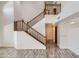 Bright foyer features wood stairs with white walls and wood look tile flooring at 514 E Vaughn Ave, Gilbert, AZ 85234