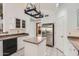 Kitchen with stainless steel refrigerator, granite countertops, and tile flooring at 514 E Vaughn Ave, Gilbert, AZ 85234