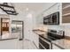 Bright kitchen with white cabinets, granite countertops, island and stainless appliances at 514 E Vaughn Ave, Gilbert, AZ 85234