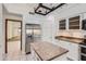 Kitchen with stainless steel refrigerator, granite countertops, and tile flooring at 514 E Vaughn Ave, Gilbert, AZ 85234