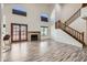 Open living room features a fireplace, staircase, and vaulted ceilings with clerestory windows at 514 E Vaughn Ave, Gilbert, AZ 85234