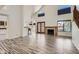 Bright living room featuring a fireplace, doors to patio, and bar seating to the kitchen at 514 E Vaughn Ave, Gilbert, AZ 85234
