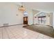 Bright open living room with tile flooring, large windows and statement chandelier at 514 E Vaughn Ave, Gilbert, AZ 85234