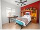 This vibrant bedroom features a red accent wall, decorative shelving, and a cozy bench at 7145 E Cuernavaco Way, Gold Canyon, AZ 85118
