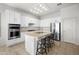 Bright kitchen features white cabinetry, stainless steel appliances, and a center island with bar stool seating at 7145 E Cuernavaco Way, Gold Canyon, AZ 85118