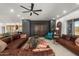 Expansive living room with leather seating, dark accent wall, and an open layout perfect for entertaining at 7145 E Cuernavaco Way, Gold Canyon, AZ 85118