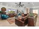 Spacious living room featuring upscale leather seating, a ceiling fan, and open access to other parts of the home at 7145 E Cuernavaco Way, Gold Canyon, AZ 85118