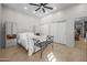 This primary bedroom has nice tile floors, a ceiling fan, a sitting bench, and custom built-ins at 7145 E Cuernavaco Way, Gold Canyon, AZ 85118