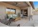 Relaxing covered patio with comfortable seating, a coffee table, and seamless access to the home's interior at 7145 E Cuernavaco Way, Gold Canyon, AZ 85118