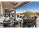 Inviting covered patio features comfortable seating, ceiling fan, and beautiful desert views, perfect for outdoor relaxation at 7145 E Cuernavaco Way, Gold Canyon, AZ 85118