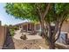 Spacious backyard featuring a covered patio, desert landscaping, and a cozy outdoor seating area at 10903 E Ocaso Ave, Mesa, AZ 85212