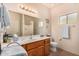 Bathroom vanity with wood cabinets, a large mirror, and plenty of counter space at 10903 E Ocaso Ave, Mesa, AZ 85212