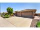 Charming single-story home showcasing a three-car garage and desert landscaping at 10903 E Ocaso Ave, Mesa, AZ 85212