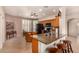 Open kitchen with granite countertops, wood cabinets, stainless steel appliances, and a center island with seating at 10903 E Ocaso Ave, Mesa, AZ 85212