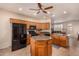 Kitchen featuring wood cabinets, granite countertops, a center island, stainless steel appliances, and ample counter space at 10903 E Ocaso Ave, Mesa, AZ 85212