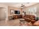 Comfortable living room with leather couches and tile flooring throughout at 10903 E Ocaso Ave, Mesa, AZ 85212