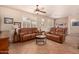 Comfortable living room with leather couches and plenty of natural light at 10903 E Ocaso Ave, Mesa, AZ 85212