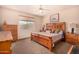 Main bedroom featuring wood furniture, a ceiling fan, and a window providing natural light at 10903 E Ocaso Ave, Mesa, AZ 85212