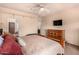 Relaxing bedroom with a wooden bed frame, a mounted television, and warm, neutral tones creating a soothing atmosphere at 10903 E Ocaso Ave, Mesa, AZ 85212