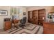 Comfortable office with built-in bookshelves, a desk, and a patterned carpet adding a touch of style at 10903 E Ocaso Ave, Mesa, AZ 85212