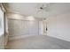 Bedroom with built-in storage, neutral carpet, and bright lighting at 11113 W Cameo Dr, Sun City, AZ 85351