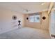 Carpeted bedroom with a ceiling fan and a window offering natural light and privacy at 11113 W Cameo Dr, Sun City, AZ 85351