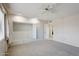 Bedroom with built-in storage, neutral carpet, and bright lighting at 11113 W Cameo Dr, Sun City, AZ 85351