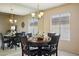 Traditional dining room features a wood table, mirrored accent wall, and a chandelier at 11113 W Cameo Dr, Sun City, AZ 85351