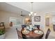 Cozy dining area with wood table set, chandelier, and open to living room at 11113 W Cameo Dr, Sun City, AZ 85351