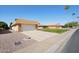Single-story brick home with desert landscaping, spacious driveway leading to a two-car garage providing ample parking at 11113 W Cameo Dr, Sun City, AZ 85351