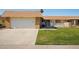 Charming single-story home with a well-manicured lawn and attached two-car garage and brick accents at 11113 W Cameo Dr, Sun City, AZ 85351
