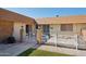 Inviting home exterior featuring a decorative white metal fence, well-kept lawn, and brick pillar accents at 11113 W Cameo Dr, Sun City, AZ 85351