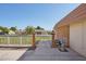 Home exterior with decorative white metal fence, brick pillars, and view of neighboring houses across the street at 11113 W Cameo Dr, Sun City, AZ 85351