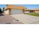 Well-maintained home featuring a two-car garage, manicured landscaping, and charming curb appeal at 11113 W Cameo Dr, Sun City, AZ 85351
