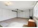 Spacious garage with painted walls and floors, storage cabinets, and an automatic door opener at 11113 W Cameo Dr, Sun City, AZ 85351