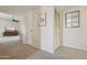 Bright hallway showcasing neutral walls, plush carpet, and classic doors, leading to comfortable living spaces at 11113 W Cameo Dr, Sun City, AZ 85351