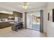 Spacious kitchen featuring tiled floors, dark wood cabinets, a breakfast bar, and sliding glass doors to the patio at 11113 W Cameo Dr, Sun City, AZ 85351