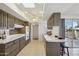 Kitchen with tile floor, a skylight and plentiful dark wood cabinets, countertop, and breakfast bar at 11113 W Cameo Dr, Sun City, AZ 85351