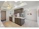 Bright kitchen features tile flooring, skylights, ceiling fan, and an island with seating at 11113 W Cameo Dr, Sun City, AZ 85351